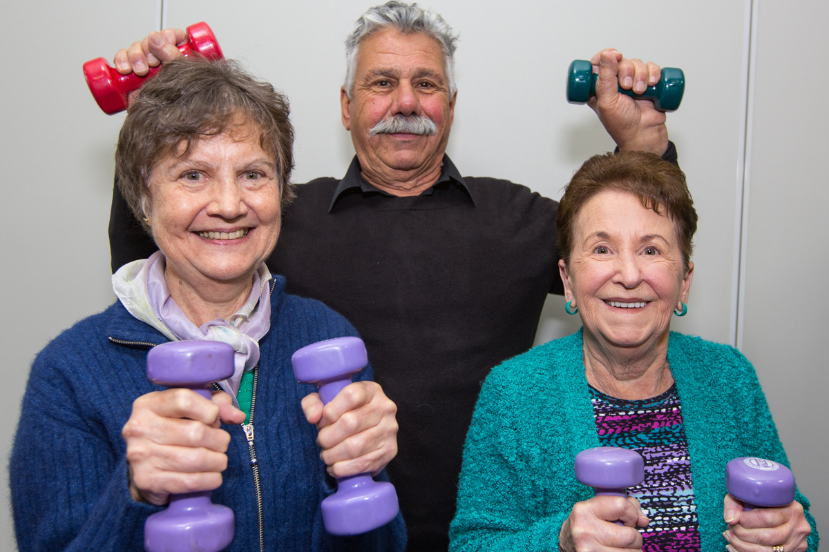 Elderly group of people holding hand weights